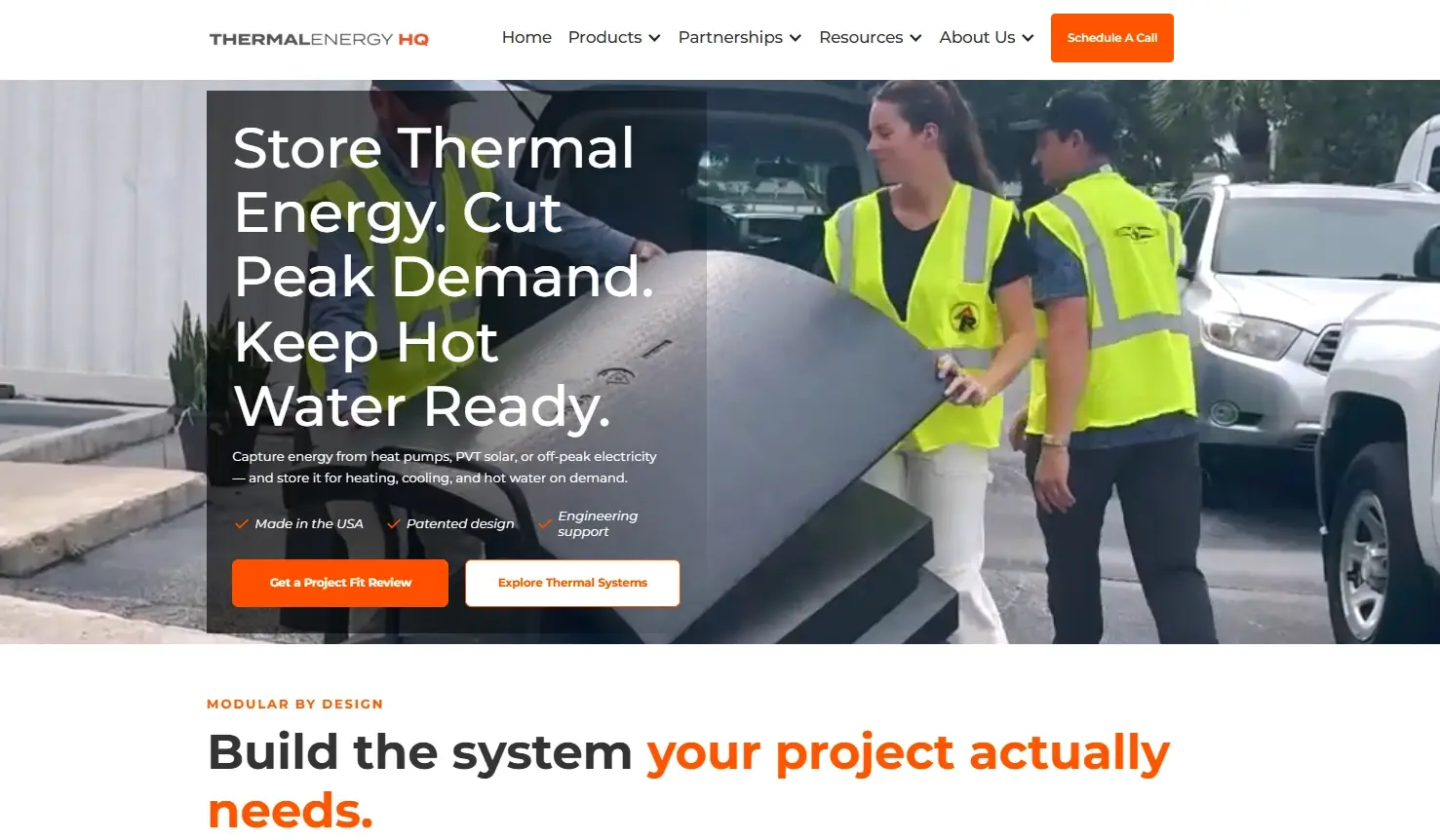 The Thermal Energy HQ homepage: the headline "Store Thermal Energy. Cut Peak Demand. Keep Hot Water Ready." beside a photo of two people carrying a ThermalTank panel.